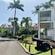 A road through Nelson's Dockyard, lined with buildings, posts, palm trees and cannons